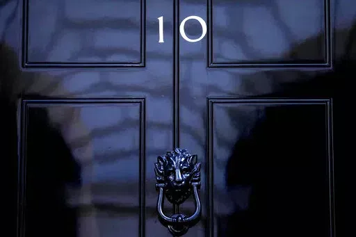 The door to 10 Downing Street in London, Friday, July 8, 2022. Under Britain's parliamentary system, the public never actually votes for its prime minister. Instead, voters tick the box for a representative from their local area, who then becomes one of Britain’s 650 Members of Parliament. The party that wins a majority forms a government and puts their leader into the prime minister's seat. (AP Photo/Frank Augstein, File)