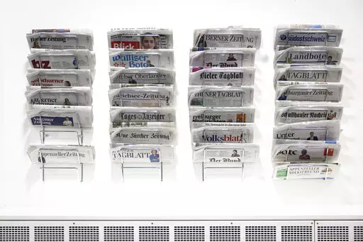 Swiss daily newspapers displayed in the Media Center of the Federal Parliament in Bern, Switzerland, Wednesday, Jan. 5, 2022. On Sunday, Feb. 13, 2022, voters in Switzerland consider on a government's public aid plan to support broadcast and print media. (Peter Klaunzer/Keystone via AP)