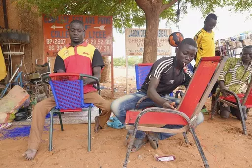 Nigerian men repair chairs in Niamey, Niger, Tuesday, Aug. 15, 2023. Niger, an impoverished country of some 25 million people, was seen as one of the last countries that Western nations could partner with in Africa's Sahel region to beat back a jihadi insurgency linked to al-Qaida and the Islamic State group. Before last month's coup, Europe and the United States had poured hundreds of millions of dollars into propping up its military. (AP Photo/Sam Mednick)