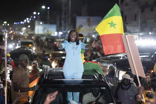 Presidential candidate Anta Babacar Ngom greets supporters during her electoral campaign caravan in Dakar, Senegal, Monday, March 11, 2024. Senegal’s only female presidential candidate may stand no chance of winning but activists say her presence alone is helping to advance a decades long campaign to achieve equality in the West African nation. (AP Photo/Sylvain Cherkaoui)