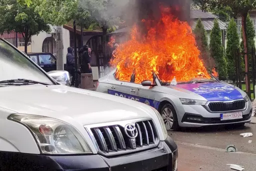 In this image made from video, Kosovar police car burns in Zvecan, northern Kosovo Friday, May 26, 2023. Serbia put its troops on the border with Kosovo on the highest state of alert Friday following clashes between ethnic Serbs and Kosovo police that left more than a dozen injured on both sides. (AP Photo)