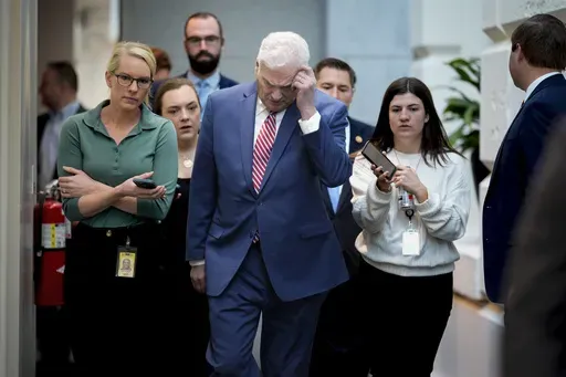 House Majority Whip Tom Emmer, R-Minn., walks with reporters on the way to a closed-door Republican Conference strategy session, at the Capitol, in Washington, Tuesday, April 1, 2025. (AP Photo/J. Scott Applewhite)