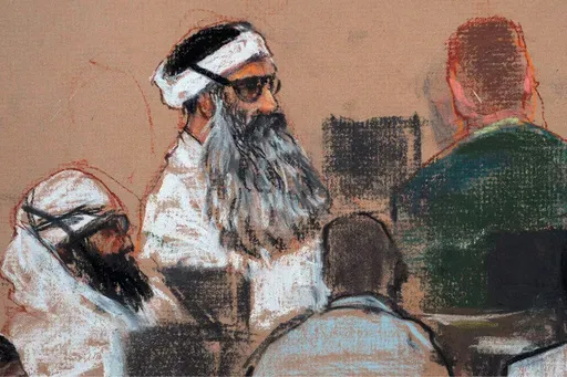 This Monday, Dec. 8, 2008 courtroom drawing by artist Janet Hamlin and reviewed by the U.S. military, shows Khalid Sheikh Mohammed, center, and co-defendant Walid Bin Attash, left, attending a pre-trial session at Guantanamo Bay Naval Base, Cuba. (AP Photo/Janet Hamlin, Pool, File)
