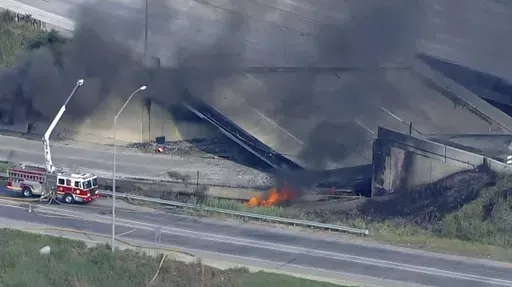 This screen grab from video provided by WPVI-TV/6ABC shows the collapsed section of I-95 with fire trucks on the scene in Philadelphia, Sunday, June 11, 2023. A report released on June 11, 2024, says the gasoline delivery truck that destroyed the I-95 bridge a year ago says gasoline spilled out from an unsecured hatch on the top of the tanker. (WPVI-TV/6ABC via AP)