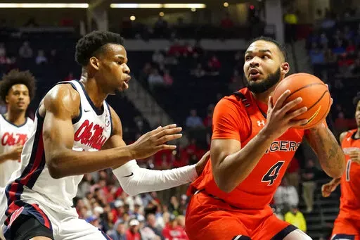 Auburn forward Johni Broome (4) looks for a shot while Mississippi forward Theo Akwuba (10) defends during the first half of an NCAA college basketball game in Oxford, Miss., Tuesday, Jan. 10, 2023. (AP Photo/Rogelio V. Solis)