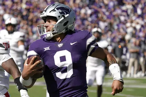 Kansas State quarterback Adrian Martinez runs the ball during the first half of an NCAA college football game against Texas Tech Saturday, Oct. 1, 2022, in Manhattan, Kan. Kansas State quarterback Adrian Martinez and Iowa linebacker Jack Campbell were among 15 players named finalists Wednesday, Oct. 26, 2022, for the William V. Campbell Trophy, given to college football's top scholar-athlete.(AP Photo/Charlie Riedel, File)