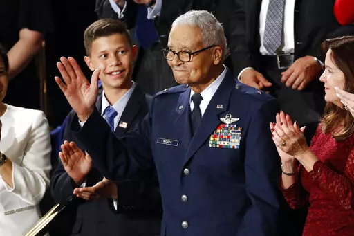 Tuskegee airman Charles McGee and his great grandson Iain Lanphier react as President Donald Trump delivers his State of the Union address to a joint session of Congress on Capitol Hill in Washington, Tuesday, Feb. 4, 2020. McGee, one of the last surviving Tuskegee Airmen who flew 409 fighter combat missions over three wars, died Sunday, Jan. 16, 2022. He was 102. (AP Photo/Patrick Semansky, File)