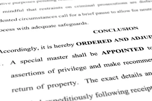 A page from the order granting a request by former President Donald Trump's legal team to appoint a special master to review documents seized by the FBI during a search of his Mar-a-Lago estate is photographed Monday, Sept. 5, 2022. The decision by U.S. District Judge Aileen Cannon came despite the objections of the Justice Department, which said an outside legal expert was not necessary in part because officials had already completed their review of potentially privileged documents. (AP Photo/J