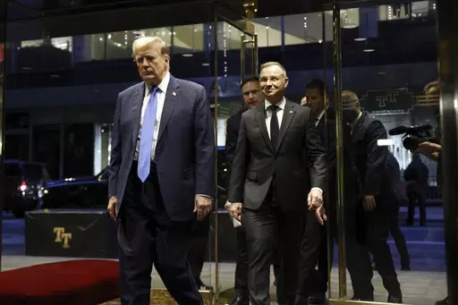 Republican presidential candidate former President Donald Trump walks with Poland's President Andrzej Duda at Trump Tower in midtown Manhattan in New York on Wednesday, April 17, 2024. (AP Photo/Stefan Jeremiah)