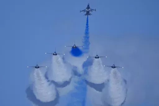 South Korean Air Force's Black Eagles aerobatic team performs during the first day of the Singapore Airshow in Singapore, Tuesday, Feb. 20, 2024. (AP Photo/Vincent Thian)