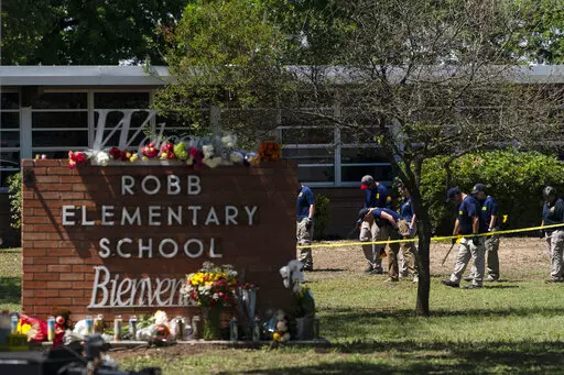 Investigators search for evidences outside Robb Elementary School in Uvalde, Texas, May 25, 2022. The children who survived the attack, which killed 19 schoolchildren and two teachers, described a festive, end-of-the-school-year day that quickly turned to terror. (AP Photo/Jae C. Hong, File)