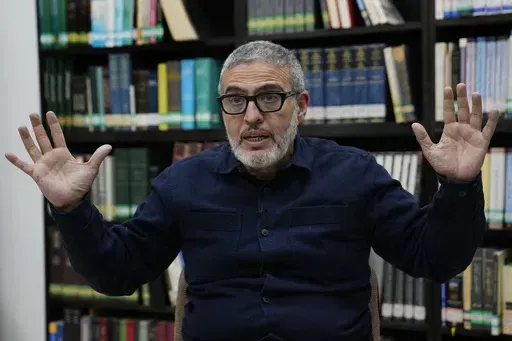 Dr. Ghassan Abu Sitta, a Palestinian-British surgeon specializing in conflict medicine, speaks during an interview at the Institute for Palestine Studies in Beirut, Lebanon, Saturday, Dec. 9, 2023. Abu Sitta, who volunteered in Gaza hospitals, said he was denied entry to France on Saturday, May 4, 2024, to speak at a French Senate meeting about the Israel-Hamas war. Authorities wouldn't give a reason for the decision. (AP Photo/Hussein Malla, File)