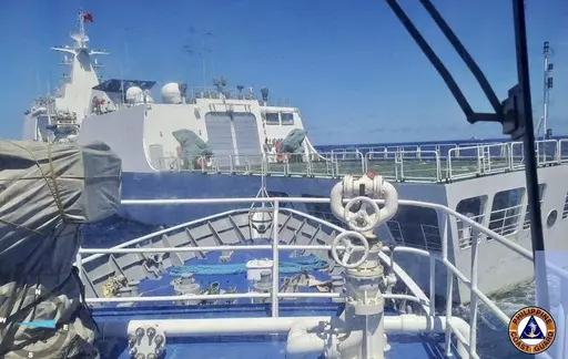In this photo provided by the Philippine Coast Guard, a Chinese Coastguard ship, front, allegedly blocks the path of a Philippine Coast Guard ship near the Philippine-occupied Second Thomas Shoal, South China Sea during a re-supply mission on Saturday Aug. 5, 2023. The Philippine military condemned on Sunday a Chinese coast guard ship's "excessive and offensive" use of a water cannon to block a Filipino supply boat from delivering new troops, food, water and fuel to a Philippine-occupied shoal i