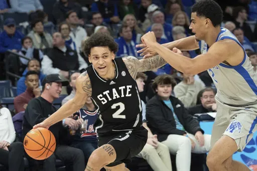 Mississippi State guard Riley Kugel (2) drives against the defense of Memphis forward Nicholas Jourdain (2) during the second half of an NCAA college basketball game Saturday, Dec. 21, 2024, in Memphis, Tenn. (AP Photo/Nikki Boertman)