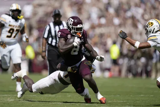 Texas A&M running back Le'Veon Moss (8) is hit by Missouri linebacker Triston Newson (14) on a run during the second half of an NCAA college football game Saturday, Oct. 5, 2024, in College Station, Texas. (AP Photo/Eric Gay)