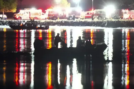 A boat works the scene in the Potomac River near Ronald Reagan Washington National Airport, Thursday, Jan. 30, 2025, in Arlington, Va. (AP Photo/Alex Brandon)