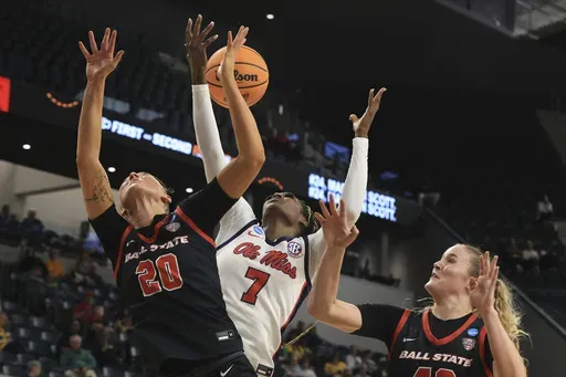 Ole Miss forward Starr Jacobs grabs the loose ball between Ball State forward Alex Richard, left, and forward Elise Stuck, right, during the second half in the first round of the NCAA college basketball tournament, Friday March 21, 2025, in Waco, Texas. (AP Photo/Jerry Larson)