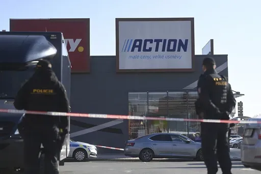 Police officers stand guard in a shopping area in Hradec Kralove, Czech Republic, at the site where two women have died in a knife attack, Thursday, Feb 20, 2025. (Josef Costarek/CTK via AP)