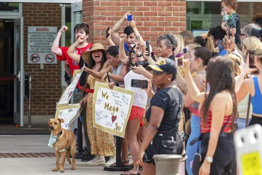 Supporters of actor Johnny Depp react as the verdict is announced in Depp's libel lawsuit against ex-wife Amber Heard outside the Fairfax County Courthouse Wednesday, June 1, 2022 in Fairfax, Va. A jury awarded Johnny Depp more than $10 million on Wednesday in his libel lawsuit against ex-wife Amber Heard, vindicating his stance that Heard fabricated claims that she was abused by Depp before and during their brief marriage.  (AP Photo/Craig Hudson)