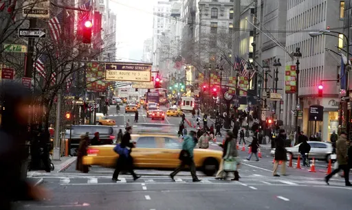 Vehicles and pedestrians make their way down Fifth Avenue in New York, Dec. 22, 2005, . (AP Photo/Diane Bondareff, File)