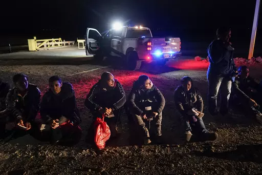 Migrants wait to be processed after crossing the border, Jan. 6, 2023, near Yuma, Ariz. A federal judge on Tuesday, July 25, blocked a rule that allows immigration authorities to deny asylum to migrants who arrive at the U.S.-Mexico border without first applying online or seeking protection in a country they passed through. But the judge delayed his ruling from taking effect immediately to give the administration time to appeal. (AP Photo/Gregory Bull, File)