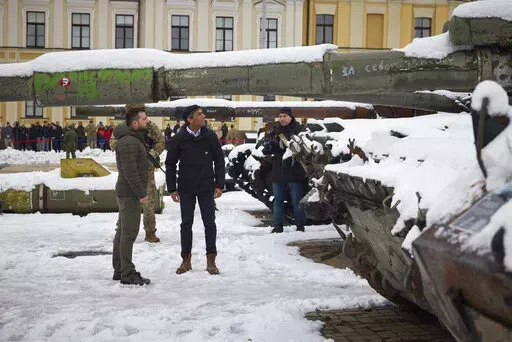 In this photo provided by the Ukrainian Presidential Press Office, Ukrainian President Volodymyr Zelenskyy, left, and British Prime Minister Rishi Sunak observe destroyed Russian military vehicles installed in downtown Kyiv, Ukraine, Saturday, Nov. 19, 2022. (Ukrainian Presidential Press Office via AP)