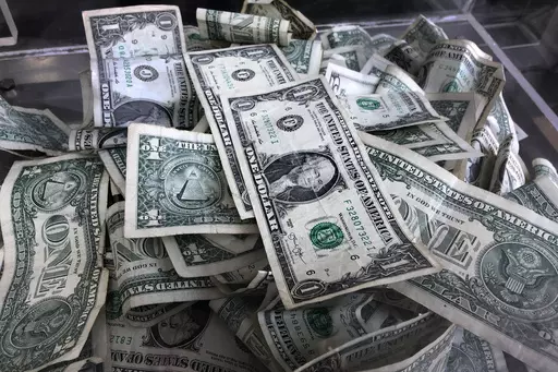 A tip box is filled with U.S. currency in New York, April 3, 2019. Taking on some degree of risk is a healthy part of making financial decisions, but it’s not always comfortable. Consider building up your emergency savings fund to help provide a buffer in case events don’t go as planned. (AP Photo/Mark Lennihan, File)