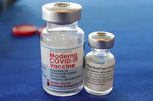 This Sept. 21, 2021 file photo shows vials of the Pfizer and Moderna COVID-19 vaccines in Jackson, Miss. Moderna is suing its main competitors Pfizer and the German drugmaker BioNTech, accusing the rivals of copying Moderna’s technology in order to make their own vaccine. Moderna said Friday, Aug. 26, 2022, that Pfizer and BioNTech’s vaccine Comirnaty infringes on patents Moderna filed several years ago protecting the technology behind its preventive shot, Spikevax.  (AP Photo/Rogelio V. Sol