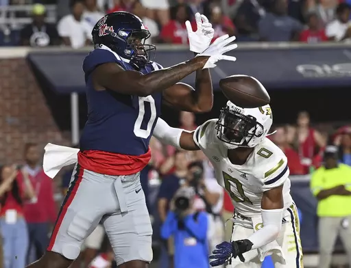 Mississippi tight end Michael Trigg, left, drops a pass under pressure from Georgia Tech defensive back Myles Sims during the first half an NCAA college football game in Oxford, Miss., Saturday, Sept. 16, 2023. (AP Photo/Thomas Graning)