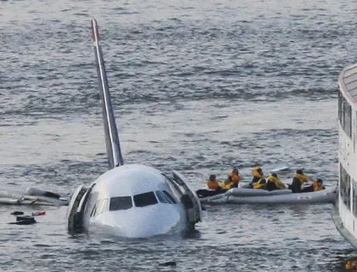 In this Jan. 15, 2009 file photo, passengers in an inflatable raft move away from US Airways Flight 1549 that went down in the Hudson River in New York. (AP Photo/Bebeto Matthews, File)