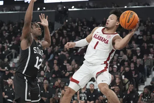 Alabama guard Mark Sears (1) attempts to pass the ball by Mississippi State guard Josh Hubbard (12) during the first half of an NCAA college basketball game, Wednesday, Jan. 29, 2025, in Starkville, Miss. (AP Photo/Rogelio V. Solis)
