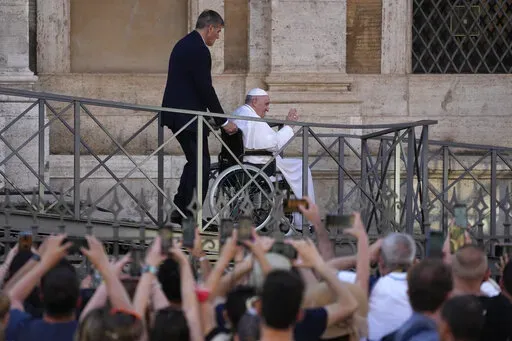 FILE-- Pope Francis greets the faithful as he leaves St. Mary Major Basilica after participating in a rosary prayer for peace, in Rome, Tuesday, May 31, 2022. Pope Francis canceled a planned July trip to Africa on doctors' orders because of ongoing knee problems, the Vatican said Friday, June 10, 2022, raising further questions about the health and mobility problems of the 85-year-old pontiff.  (AP Photo/Gregorio Borgia)