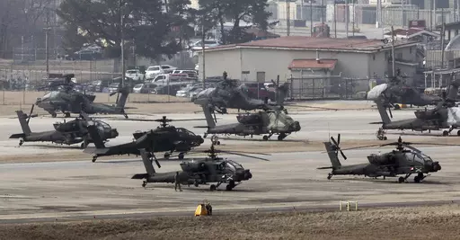 U.S. Army Apache helicopters take off at Camp Humphreys in Pyeongtaek, South Korea, Monday, March 4, 2024. North Korea called the ongoing South Korean-U.S. military drills a plot to invade the country, as it threatened Tuesday to take unspecified "responsible" military steps in response. (Kwon June-woo/Yonhap via AP)