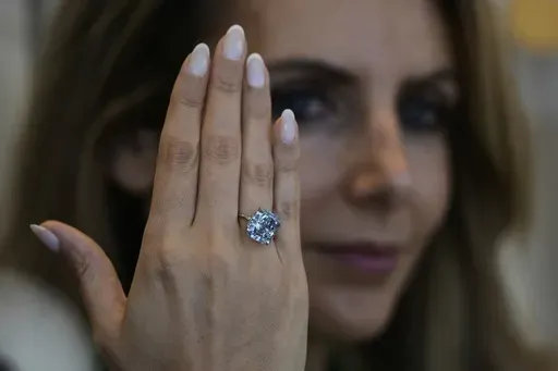 Sotheby's Deputy Chairman, Middle East & Head of Sotheby's UAE, Katia Noun Boueiz wears the Mediterranean Blue diamond during its worldwide debut in Abu Dhabi, United Arab Emirates, Tuesday, April 8, 2025. (AP Photo/Altaf Qadri)