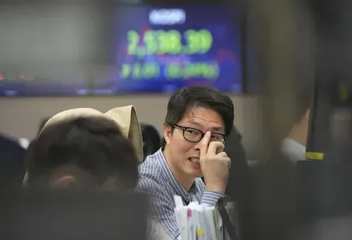 A currency trader works at the foreign exchange dealing room of the KEB Hana Bank headquarters in Seoul, South Korea, Monday, April 24, 2023. Asian stock markets were mixed Monday ahead of a U.S. economic update this week that is expected to show growth slowing. (AP Photo/Ahn Young-joon)