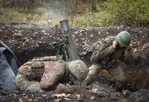 Ukrainian soldiers fire a mortar in the front line near Bakhmut, in the Donetsk region, Ukraine, Thursday, Oct. 27, 2022. (AP Photo/Efrem Lukatsky)