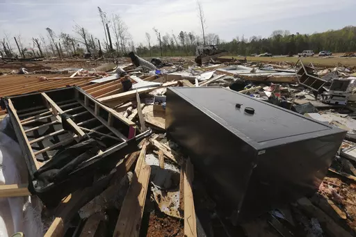 A gun vault and broken debris is all that is left of the home of Chad Mills along Hwy 15, Saturday, April 1, 2023 in Pontotoc, Miss. Storms that dropped possibly dozens of tornadoes killed multiple people in small towns and big cities across the South and Midwest, tearing a path through the Arkansas capital, collapsing the roof of a packed concert venue in Illinois, and stunning people throughout the region Saturday with the damage's scope.(Thomas Wells/The Northeast Mississippi Daily Journal vi