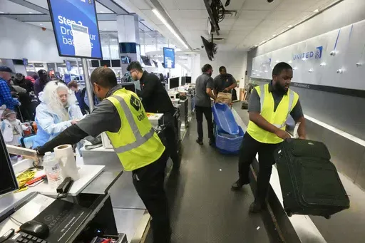 Passenger drop off their baggage at United Airlines in C Terminal at George Bush Intercontinental Airport, Thursday, Dec. 21, 2023, in Houston. The Biden administration issued final rules Wednesday, April 24, 2024, to require airlines to automatically issue cash refunds for things like delayed flights and to better disclose fees for baggage or canceling a reservation. (Brett Coomer/Houston Chronicle via AP, File)