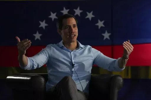Opposition leader Juan Guaido speaks during an interview with the Associated Press in Caracas, Venezuela, Thursday, Feb. 10, 2022. Three years after he proclaimed himself the legitimate leader of Venezuela, Guaido, his U.S.-backed opposition and other adversaries of President Nicolas Maduro will convene this week in Caracas, to work on a big-tent strategy as they gear up for a presidential election they would like to see happen before 2024. (AP Photo/Ariana Cubillos)
