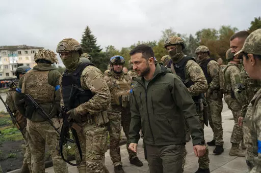 Surrounded by soldiers the Ukrainian President Volodymyr Zelenskyy attends a national flag-raising ceremony in the freed Izium, Ukraine, Wednesday, Sept. 14, 2022. A tart retort by Zelenskyy to a U.S. offer of help and a call by former U.S. President Donald Trump for the "termination" of parts of the Constitution top a Yale Law School librarian's list of the most notable quotations of 2022. (AP Photo/Leo Correa, File)