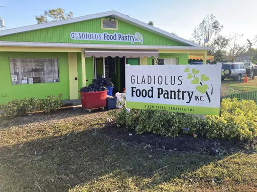 Garbage is piled outside the Gladiolus Food Pantry in Harlem Heights, Fla, Saturday, Oct. 1, 2022. The Gladiolus Food Pantry usually hands out supplies on Wednesdays to about 240 families so when Hurricane Ian swept through that day and cancelled their distribution it was full of flats of canned black beans, bags of rice, meats, bread and produce _ food that helps families hurting from rising rents and inflation make ends meet. By Saturday afternoon much of that food was in the garbage. (Rebecca