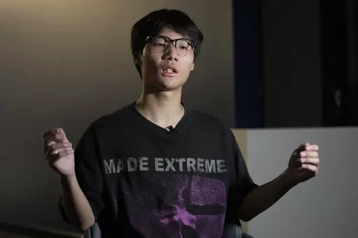 Gao Peng, son of Chinese dissident Gao Zhi, speaks during an interview with The Associated Press in Bangkok, Thailand, on July 17, 2023. Since landing in Thailand July 3, he says he has been accused of making bomb threats, put on an EU travel blacklist, and seem his mother and 16-year-old sister detained and threatened with deportation back to China. The threats, made in the family's names against airports, luxury hotels and the Chinese embassy in Bangkok derailed their plans to join Gao Zhi in 