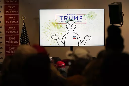 A video plays before former President Donald Trump speaks at a rally at Terrace View Event Center in Sioux Center, Iowa, Friday, Jan. 5, 2024. Well before Trump takes the stage, a waiting audience of hundreds of supporters sits captivated as dramatic music begins to swell throughout the room. On projector screens, a rotating Planet Earth appears. “Making America Great Again starts one place on Earth, and one place only,” a deep-voiced narrator begins as the image zooms into the middle of the