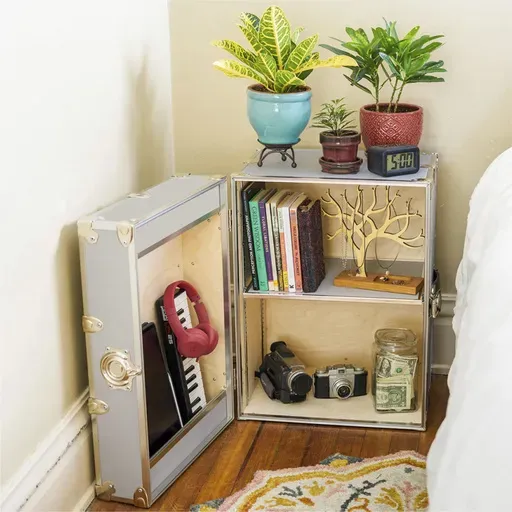 This image provided by Dormify shows a side table. The classic trunk is downsized and transformed into a side table, complete with lockable storage for valuables. (Dormify via AP)