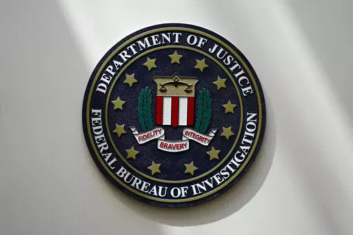 The FBI seal is pictured in Omaha, Neb., Aug. 10, 2022. The FBI is searching for a Florida woman who was supposed to stand trial Monday, March 6, 2023, on charges stemming from the Jan. 6, 2021, Capitol attack as well as another riot defendant who has gone missing. An FBI agent said Monday that a federal judge in Washington issued bench warrants for the arrest of Olivia Pollock and Joseph Hutchinson III last week after the court was notified that they had tampered with or removed the ankle monit