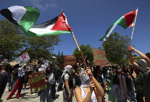 University of California, Santa Cruz graduate students and other academic workers in the UAW 4811 union begin a strike and are joined by UCSC students for Justice in Palestine as they picket the main entrance to campus on Monday, May 20, 2024, in Santa Cruz, Calif. (Shmuel Thaler/The Santa Cruz Sentinel via AP)