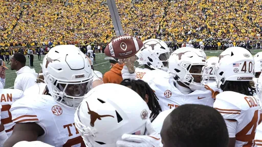 Texas defensive back Andrew Mukuba celebrates his interception with the turnover sword against Michigan in the first half of an NCAA college football game in Ann Arbor, Mich., Saturday, Sept. 7, 2024. (AP Photo/Paul Sancya)