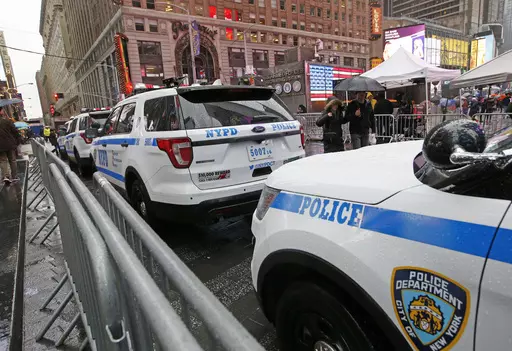 A line of police cars are parked along a street in Times Square, Thursday, Dec. 29, 2016, in New York. A New York City police officer is speaking out against the use of "courtesy cards" by friends and relatives of his colleagues on the force, accusing department leaders of maintaining a sprawling system of impunity that lets people with a connection to law enforcement avoid traffic tickets. (AP Photo/Kathy Willens, File)