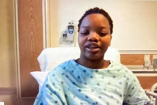 In this image taken from a video screen, Tafara Williams speaks to reporters from her hospital bed during a Zoom meeting Tuesday, Oct. 27, 2020, in Libertyville, Ill. A suburban Chicago police officer who shot a Black couple inside a vehicle — killing a 19-year-old man and wounding his girlfriend, Williams — has been charged with second-degree murder and involuntary manslaughter. Court records state Dante Salinas was charged in connection with the Oct. 20, 2020, shooting death of Marcellis S