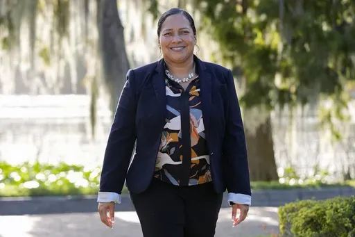 Marisol Ortega, a Polk County resident that commutes to her job in Orlando walks at a park Thursday, Nov. 14, 2024, in Orlando, Fla. (AP Photo/John Raoux)